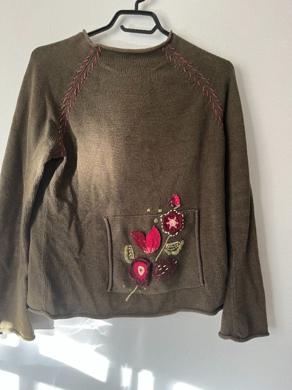 Little green  knitted sweater for women with pocket and flower in front.